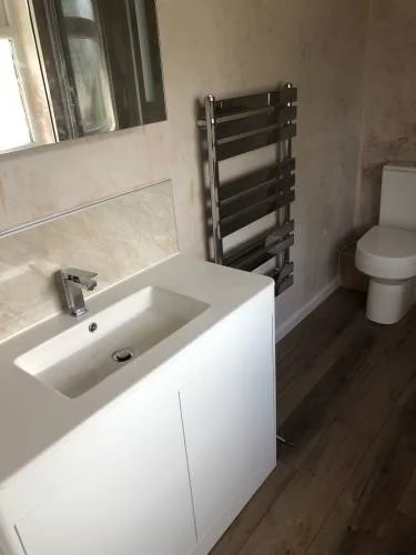 Bathroom basin, vanity unit and towel radiator